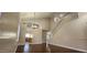 Bright living room featuring high ceilings, an elegant chandelier, hardwood floors and staircase access at 846 W Straford Ave, Gilbert, AZ 85233