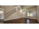 Hardwood living room featuring a staircase, a ceiling fan, and a bright window for natural light at 846 W Straford Ave, Gilbert, AZ 85233