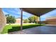 Covered patio overlooking the expansive green backyard, ideal for relaxing and enjoying the outdoors at 846 W Straford Ave, Gilbert, AZ 85233