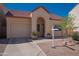 Welcoming single-Gathering home featuring a garage, desert landscaping, and inviting entrance at 1027 W Julie Dr, Tempe, AZ 85283