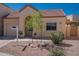 Inviting single-level home with desert landscaping and charming arched entryway at 1027 W Julie Dr, Tempe, AZ 85283
