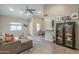 Open-concept living room featuring high ceilings, a ceiling fan, and tile flooring at 1027 W Julie Dr, Tempe, AZ 85283