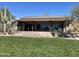 Rear exterior with desert landscaping, covered terrace, and grand staircase at 10351 E Pine Valley Dr, Scottsdale, AZ 85255