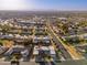 An aerial view of a neighborhood featuring single-Gathering homes, streets, desert landscaping, and beautiful mountains at 10521 W Roundelay Cir, Sun City, AZ 85351