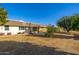 Exterior view of home showing spacious backyard with mature trees at 10521 W Roundelay Cir, Sun City, AZ 85351