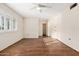 Cozy bedroom with wood floors, neutral walls, and a window offering natural light at 10521 W Roundelay Cir, Sun City, AZ 85351
