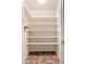 Well-organized closet with multiple shelves for optimal storage space and linoleum floor at 10521 W Roundelay Cir, Sun City, AZ 85351