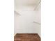 Spacious closet featuring wooden floors, white walls, and multiple rods for maximum storage and organization at 10521 W Roundelay Cir, Sun City, AZ 85351