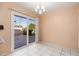 Bright dining area with tile floor and sliding glass door offering views of the landscaped backyard at 10521 W Roundelay Cir, Sun City, AZ 85351