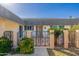 Single level home featuring desert landscaping and a gated front entry at 10521 W Roundelay Cir, Sun City, AZ 85351
