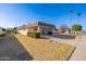 Single level home featuring desert landscaping, a two car carport, and palm trees at 10521 W Roundelay Cir, Sun City, AZ 85351