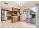 Kitchen with stainless steel appliances, granite countertops, and tile flooring, next to outdoor access at 10521 W Roundelay Cir, Sun City, AZ 85351