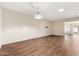 Large living room featuring a decorative pendant light, a skylight, and wood floors at 10521 W Roundelay Cir, Sun City, AZ 85351