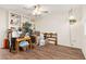 Spacious living room with wood-look floors, built in shelving, ceiling fan, and potential for customization at 10521 W Roundelay Cir, Sun City, AZ 85351