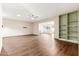 Open concept living room with hardwood floors, built-in shelves, and plenty of natural light at 10521 W Roundelay Cir, Sun City, AZ 85351