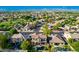 Aerial view of the neighborhood showing mature landscaping and many single Gathering homes with mountain views at 10649 E Lomita Ave, Mesa, AZ 85209