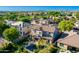 Aerial view of a large two story home, backyard pool with rock waterfall, and lush green landscaping at 10649 E Lomita Ave, Mesa, AZ 85209