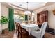 Elegant dining room with stylish furniture, decorative centerpiece, and abundant natural light at 10649 E Lomita Ave, Mesa, AZ 85209