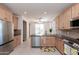 Well-lit kitchen featuring stainless steel appliances, light wood cabinets, and granite countertops at 10649 E Lomita Ave, Mesa, AZ 85209