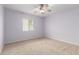 Neutral colored bedroom with carpet flooring and a ceiling fan fixture at 10834 N 45Th St, Phoenix, AZ 85028