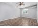 Airy bedroom featuring modern ceiling fan, hard wood floors, and natural light from a window at 10834 N 45Th St, Phoenix, AZ 85028