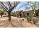 Tan home exterior with a stone yard, desert landscaping, and unique architectural design at 10834 N 45Th St, Phoenix, AZ 85028