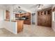 Bright kitchen featuring tile floors, stainless steel appliances, wood cabinets, and a spacious layout at 10834 N 45Th St, Phoenix, AZ 85028
