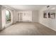 Open living room with neutral carpet, bright lighting, and a view into the dining area and kitchen at 10834 N 45Th St, Phoenix, AZ 85028