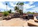 Outdoor kitchen features grill, pizza oven, stone patio, and seating offering a delightful cooking space at 10834 N 45Th St, Phoenix, AZ 85028