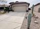 Well-maintained home with a two-car garage, desert landscaping, and a concrete driveway at 1203 W Mesquite Tree Ln, San Tan Valley, AZ 85143