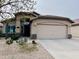 Charming home featuring desert landscaping and an attached two-car garage at 1203 W Mesquite Tree Ln, San Tan Valley, AZ 85143