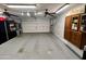 Spacious garage with storage cabinets, ceiling fans, and a sectional garage door at 1203 W Mesquite Tree Ln, San Tan Valley, AZ 85143