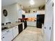 Bright kitchen with white cabinets, tile flooring, and sleek black appliances at 1203 W Mesquite Tree Ln, San Tan Valley, AZ 85143