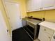Laundry room with modern washer and dryer, cabinets, and white countertops at 1203 W Mesquite Tree Ln, San Tan Valley, AZ 85143