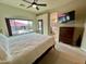 Bright main bedroom featuring a king bed and window with a view to the backyard pool at 1203 W Mesquite Tree Ln, San Tan Valley, AZ 85143