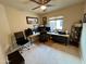 Home office featuring a ceiling fan, a large window and a three-monitor computer workstation at 1203 W Mesquite Tree Ln, San Tan Valley, AZ 85143