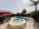 Backyard with a swimming pool and attached spa, covered patio, and lush desert landscaping at 1203 W Mesquite Tree Ln, San Tan Valley, AZ 85143