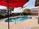 Backyard boasts a sparkling pool with spa, patio, tropical landscaping, and outdoor seating at 1203 W Mesquite Tree Ln, San Tan Valley, AZ 85143