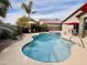 Beautiful backyard oasis featuring a private pool, spa, patio, and desert landscaping at 1203 W Mesquite Tree Ln, San Tan Valley, AZ 85143