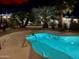 Enjoy a night swim in your private pool surrounded by desert landscaping and elegant lighting at 1203 W Mesquite Tree Ln, San Tan Valley, AZ 85143