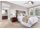 Well-lit main bedroom featuring a ceiling fan, carpet, and adjacent bathroom with glass shower at 13225 W Skinner Dr, Peoria, AZ 85383