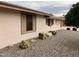 Close up showing the low maintenance desert landscaping in the front yard of this tan single story home at 14433 N Cameo Dr, Sun City, AZ 85351