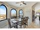 Bright dining room with arched windows and a decorative vase as a centerpiece at 15025 E Ridgeway Dr, Fountain Hills, AZ 85268