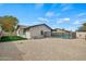 Expansive backyard with gravel landscaping and the exterior of the home, plus fenced in pool at 15031 N 37Th Ave, Phoenix, AZ 85053