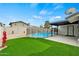 Private backyard with fenced-in pool, artificial turf, and covered patio at 15031 N 37Th Ave, Phoenix, AZ 85053
