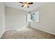 Cozy bedroom featuring neutral walls, plush carpet, a ceiling fan, and plantation shutters at 15031 N 37Th Ave, Phoenix, AZ 85053