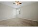 A carpeted bedroom features a ceiling fan and a window with shutters at 15031 N 37Th Ave, Phoenix, AZ 85053