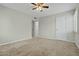 A bedroom with carpet and a ceiling fan and two white doors at 15031 N 37Th Ave, Phoenix, AZ 85053