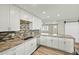 Bright kitchen with stainless steel appliances, granite countertops, and mosaic tile backsplash at 15031 N 37Th Ave, Phoenix, AZ 85053