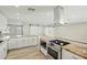 Open-concept kitchen with stainless steel appliances, modern hood, and granite countertops at 15031 N 37Th Ave, Phoenix, AZ 85053